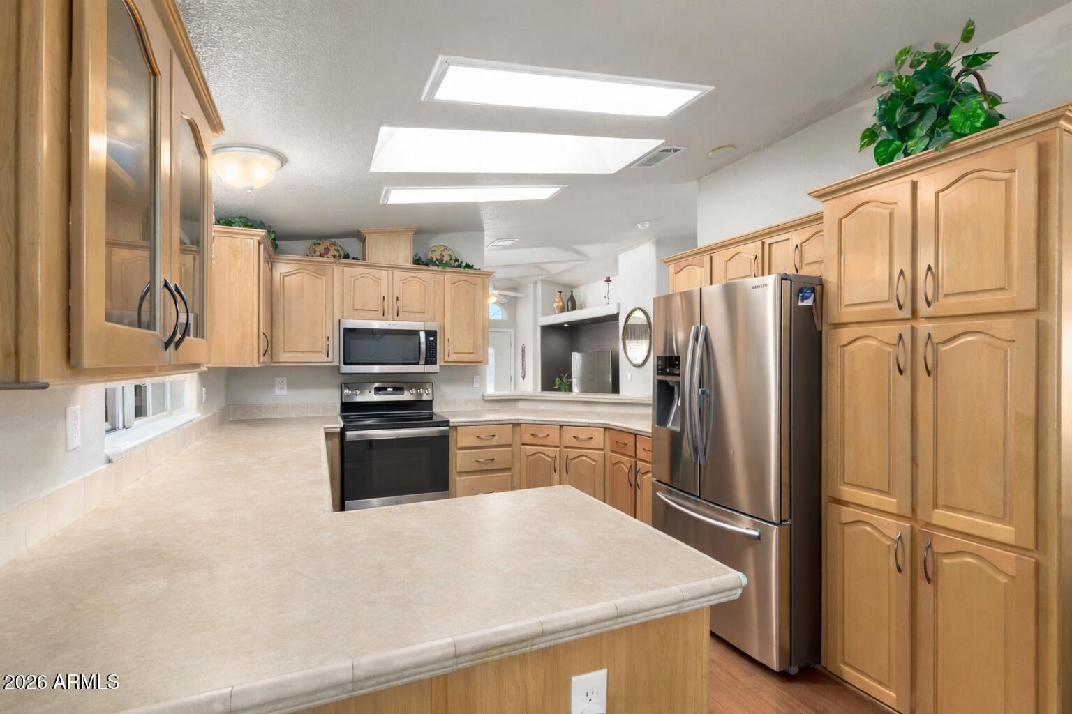 3301 South Goldfield Road, Unit 4086 Apache Junction, AZ 85119 - Photo 3 of 41 a kitchen with stainless steel appliances a refrigerator sink and stove