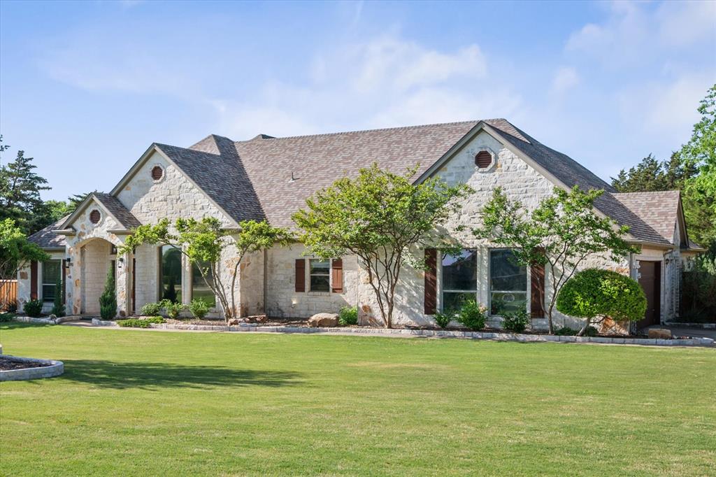 a front view of house with yard and green space