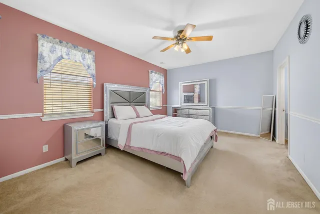 a bedroom with bed and a chandelier