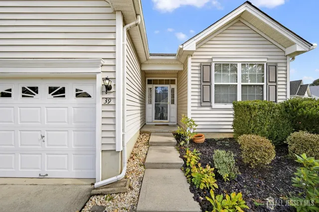 a living room with furniture and a kitchen