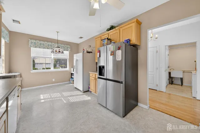 a utility room with dryer washer and a view of living room