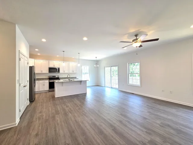 a view of kitchen and hall with wooden floor