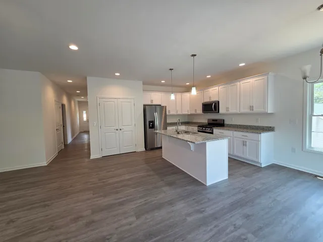 a kitchen with sink stove and microwave
