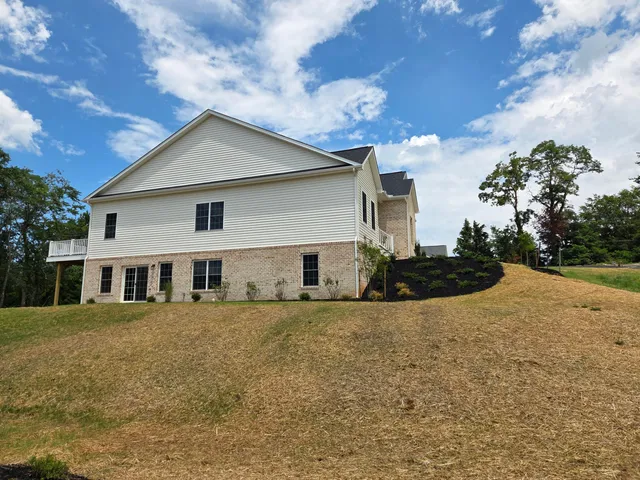 a view of a backyard with plants and a patio