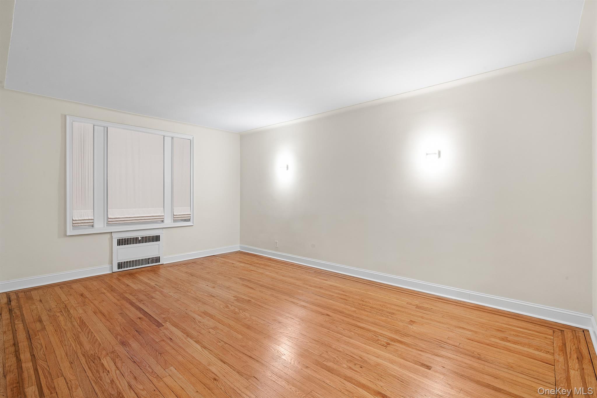 110-07 73rd Road, Unit 2K Queens, NY 11375 - Photo 11 of 17 a view of empty room with wooden floor