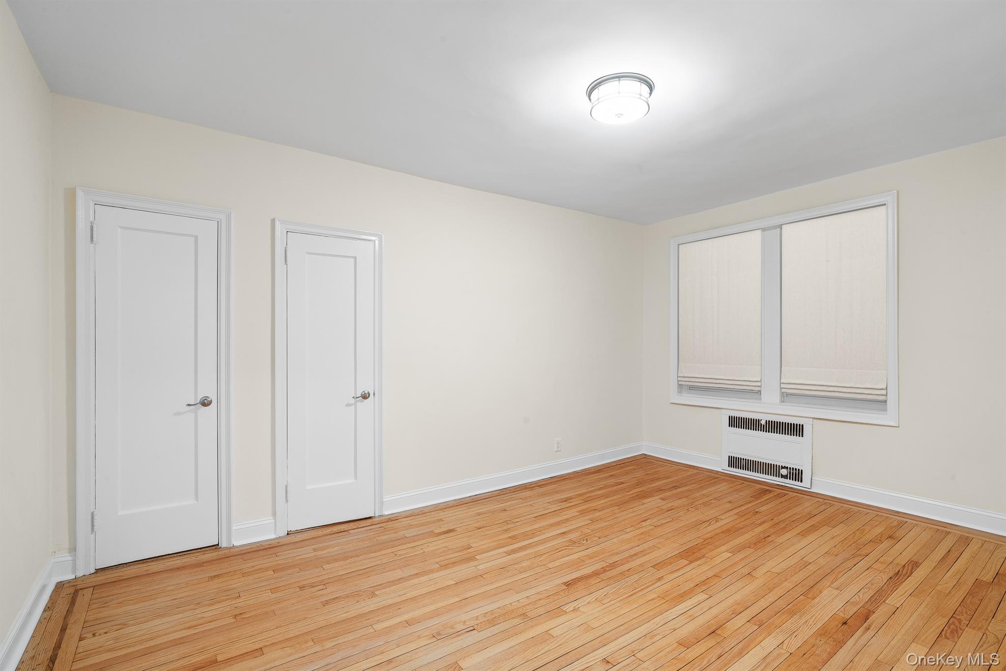 110-07 73rd Road, Unit 2K Queens, NY 11375 - Photo 14 of 17 a view of empty room with wooden floor
