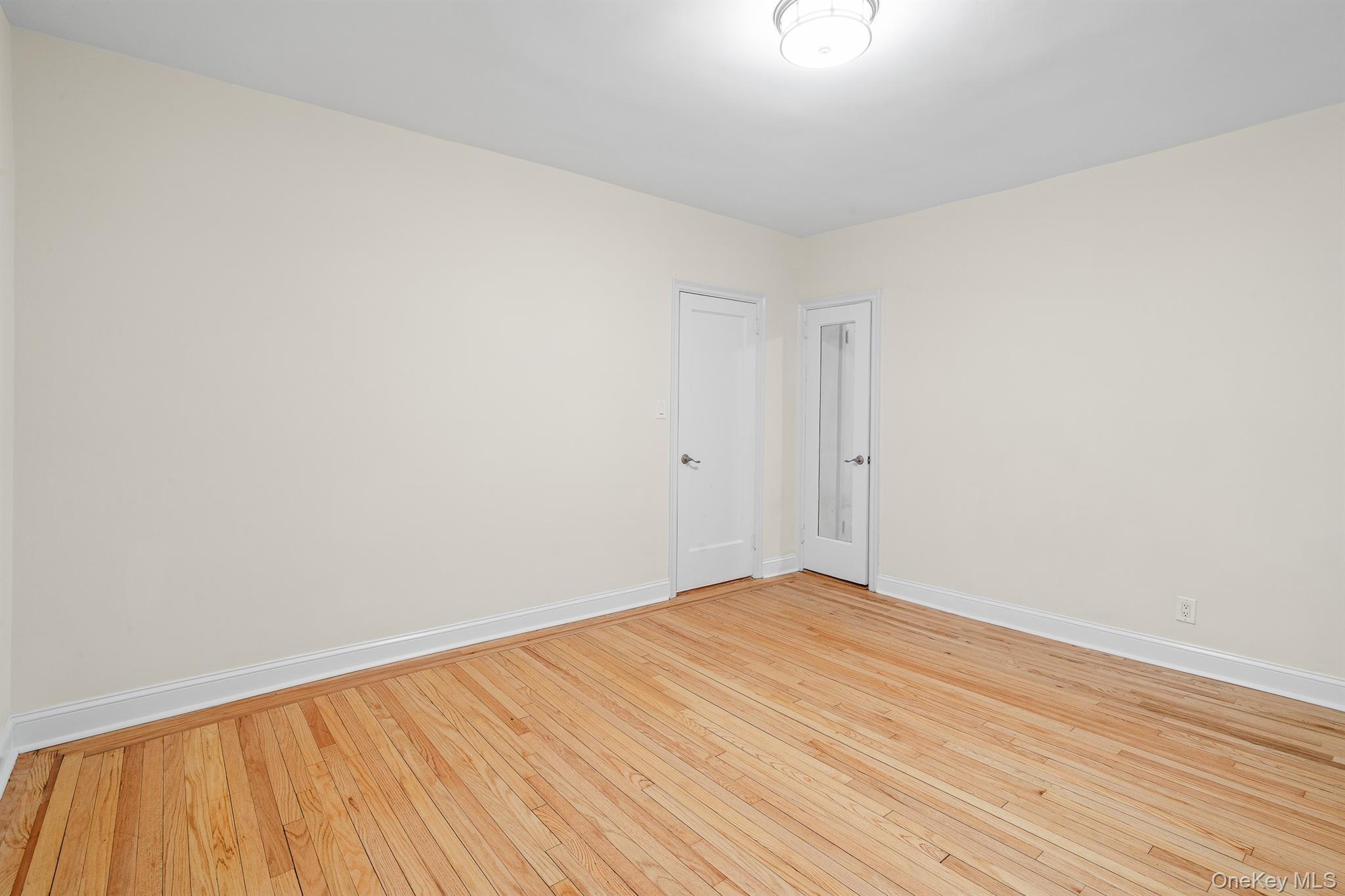 110-07 73rd Road, Unit 2K Queens, NY 11375 - Photo 17 of 17 a view of empty room with wooden floor