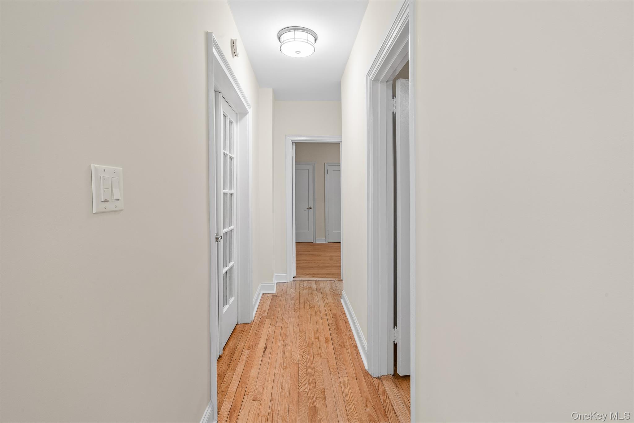 110-07 73rd Road, Unit 2K Queens, NY 11375 - Photo 5 of 17 a view of a hallway with wooden floor and staircase