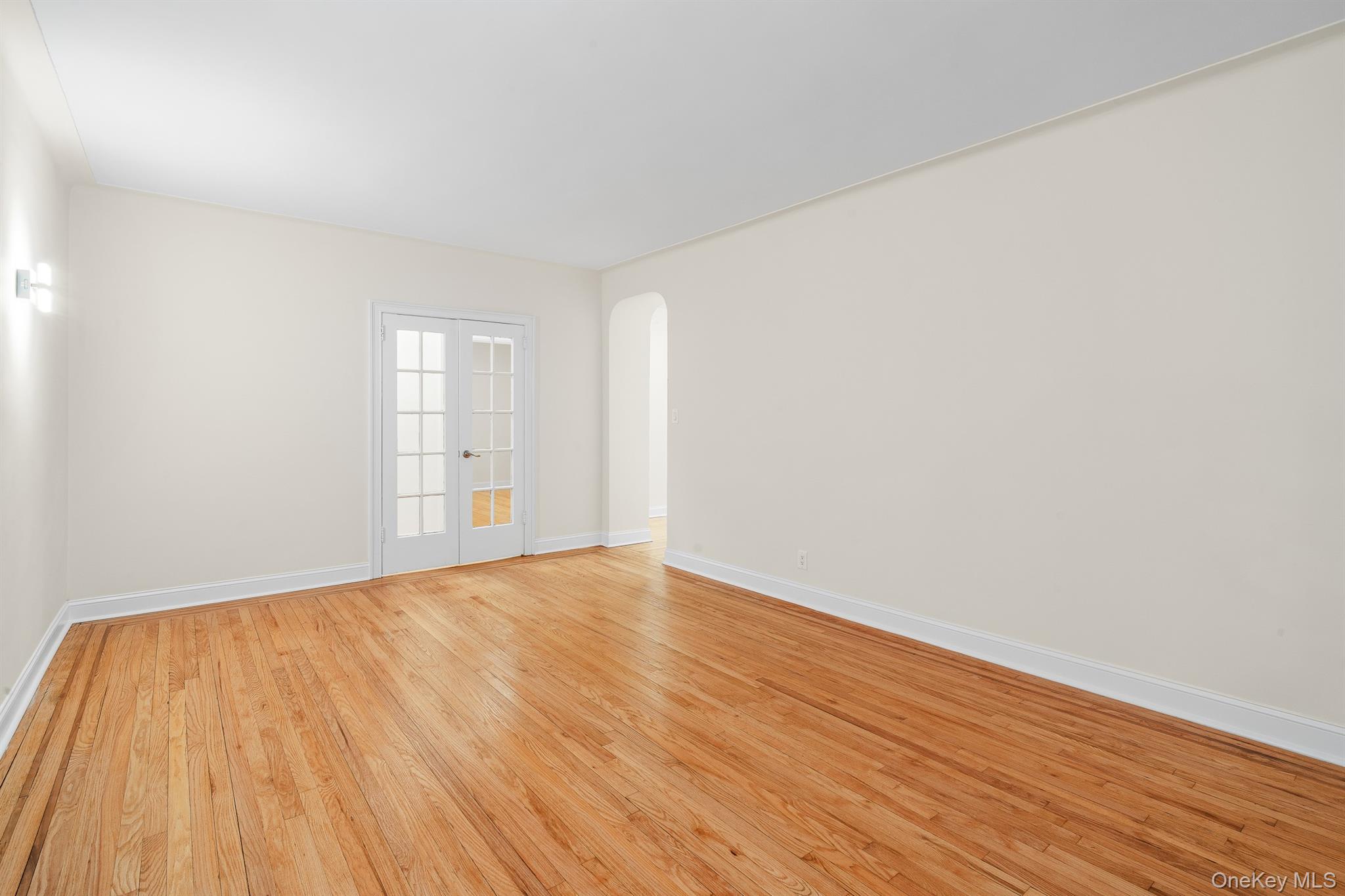 110-07 73rd Road, Unit 2K Queens, NY 11375 - Photo 10 of 17 a view of empty room with wooden floor and fan