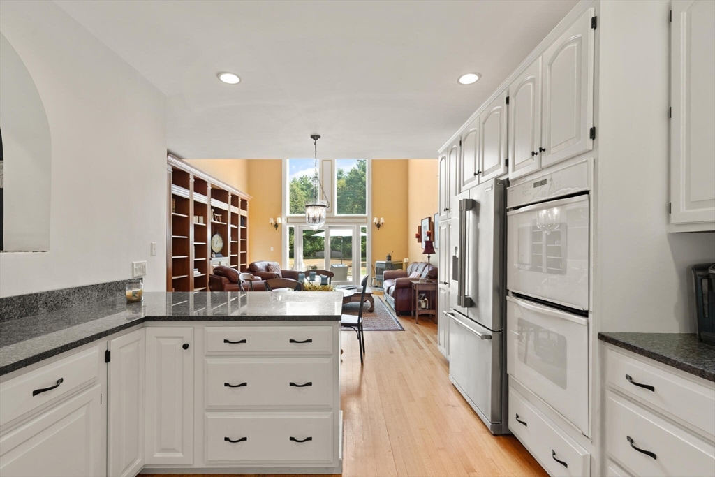 26 Cross Road Boxford, MA 01921 - Photo 12 of 41 a kitchen with white cabinets and refrigerator