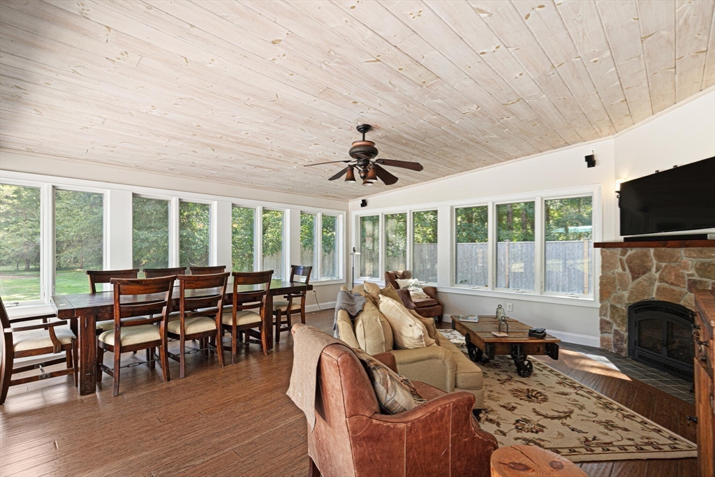 26 Cross Road Boxford, MA 01921 - Photo 15 of 41 a living room with furniture a fireplace and a floor to ceiling window
