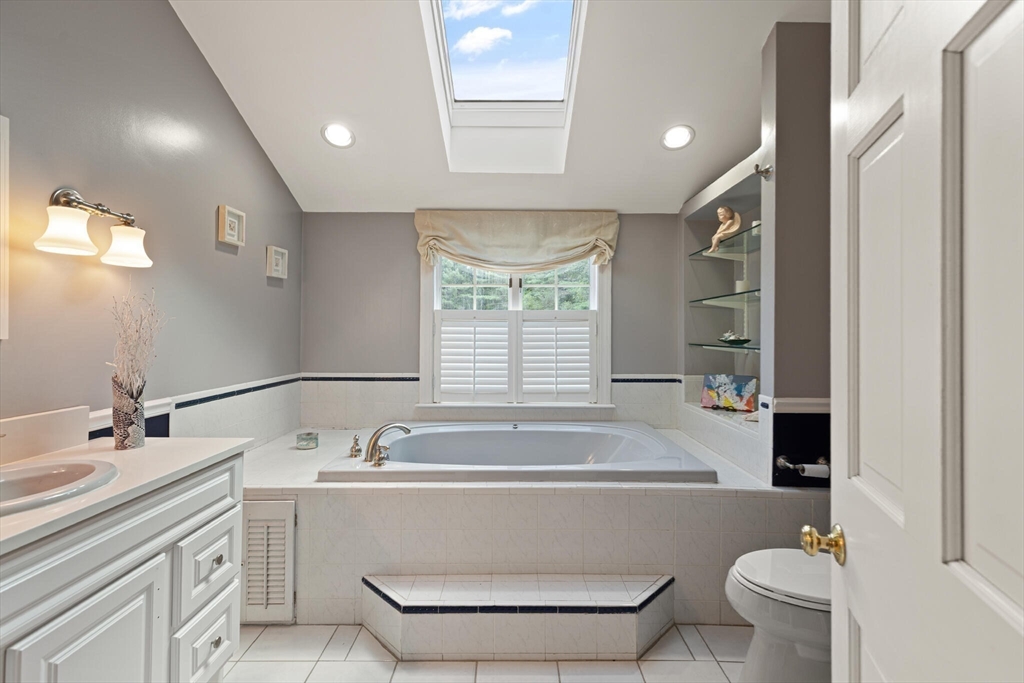 26 Cross Road Boxford, MA 01921 - Photo 25 of 41 a bathroom with a bathtub a sink and a window