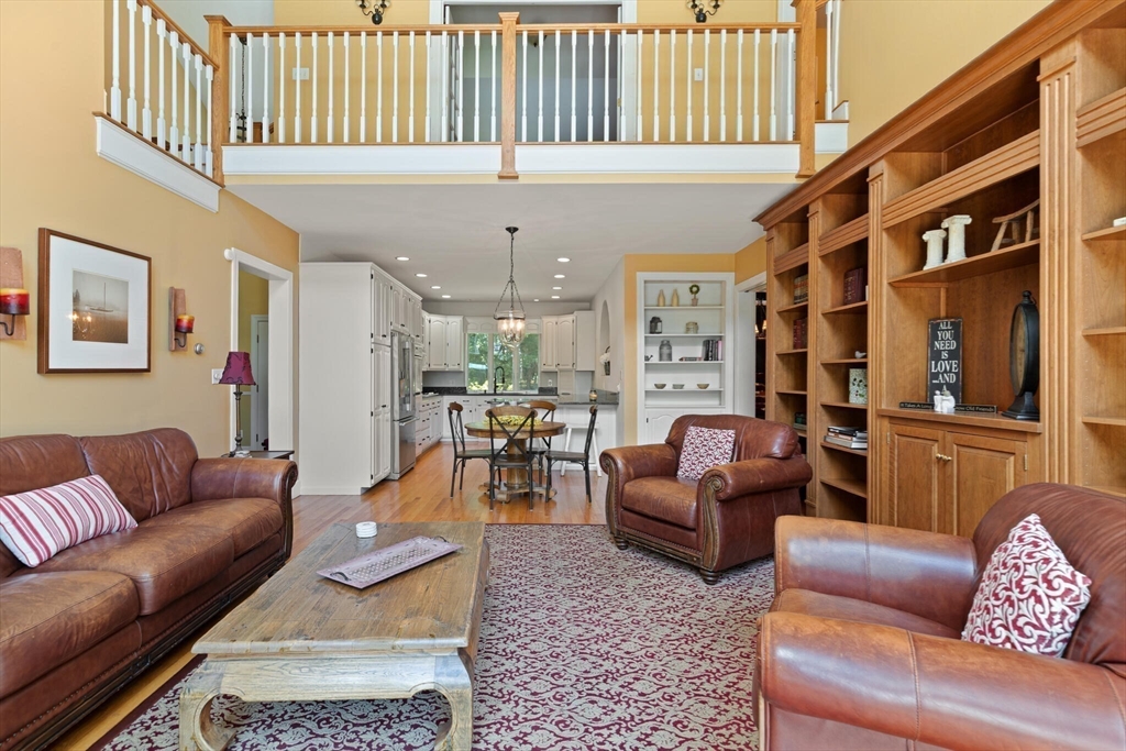 26 Cross Road Boxford, MA 01921 - Photo 7 of 41 a living room with furniture a couch and paintings on the wall