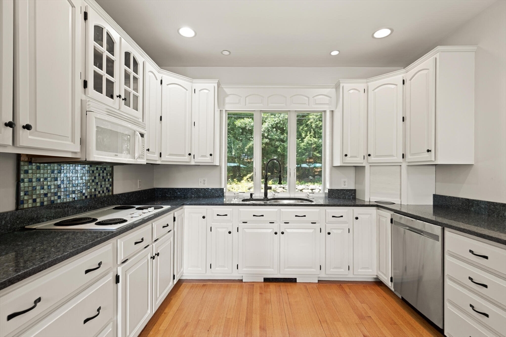 26 Cross Road Boxford, MA 01921 - Photo 9 of 41 a kitchen with granite countertop white cabinets and white appliances