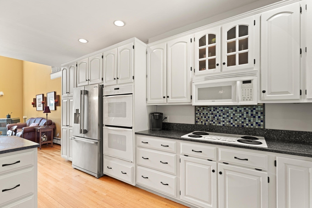26 Cross Road Boxford, MA 01921 - Photo 10 of 41 a kitchen with granite countertop white cabinets and stainless steel appliances