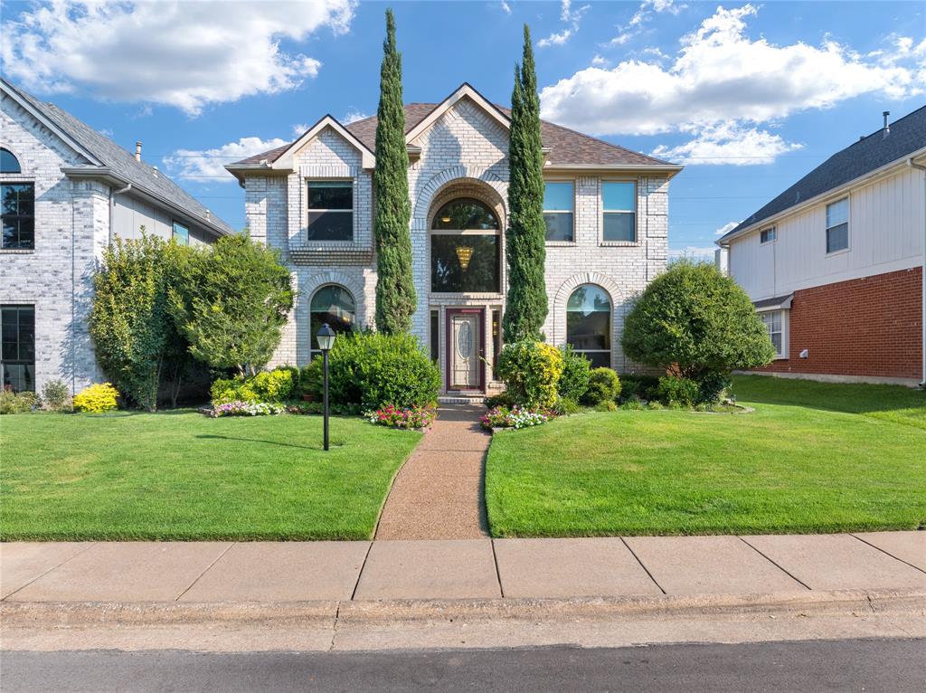 4247 Millview Lane Dallas, TX 75287 - Photo 1 of 1 a front view of a house with a garden and plants