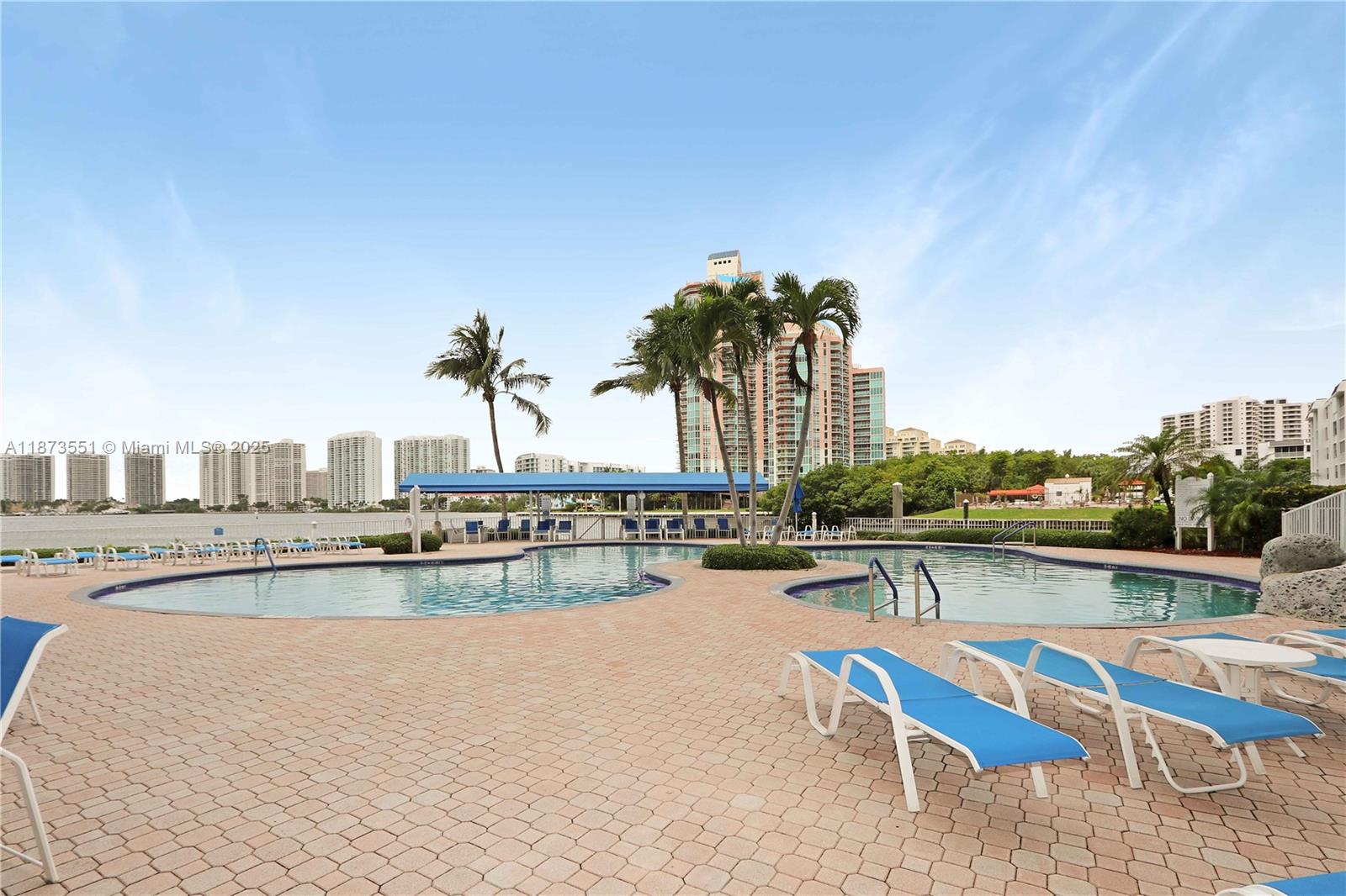 3530 Mystic Pointe Drive, Unit 2402 Aventura, FL 33180 - Photo 30 of 33 a view of a swimming pool with outdoor seating