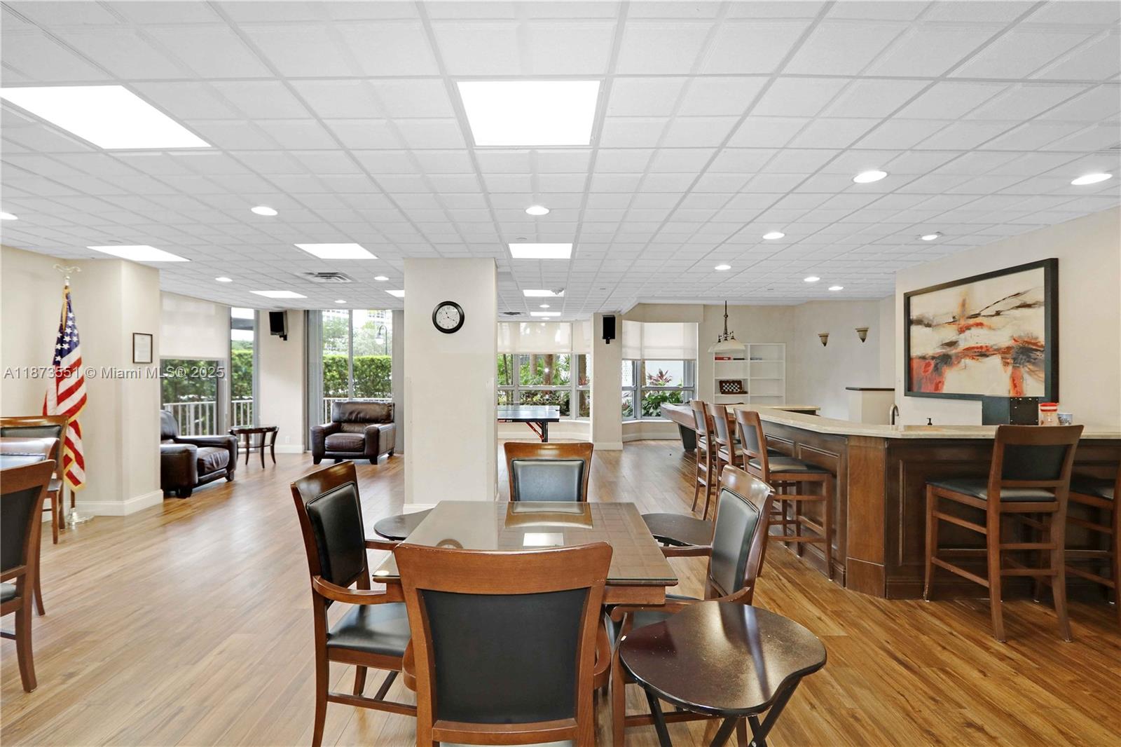 3530 Mystic Pointe Drive, Unit 2402 Aventura, FL 33180 - Photo 32 of 33 a view of a dining room with furniture window and wooden floor
