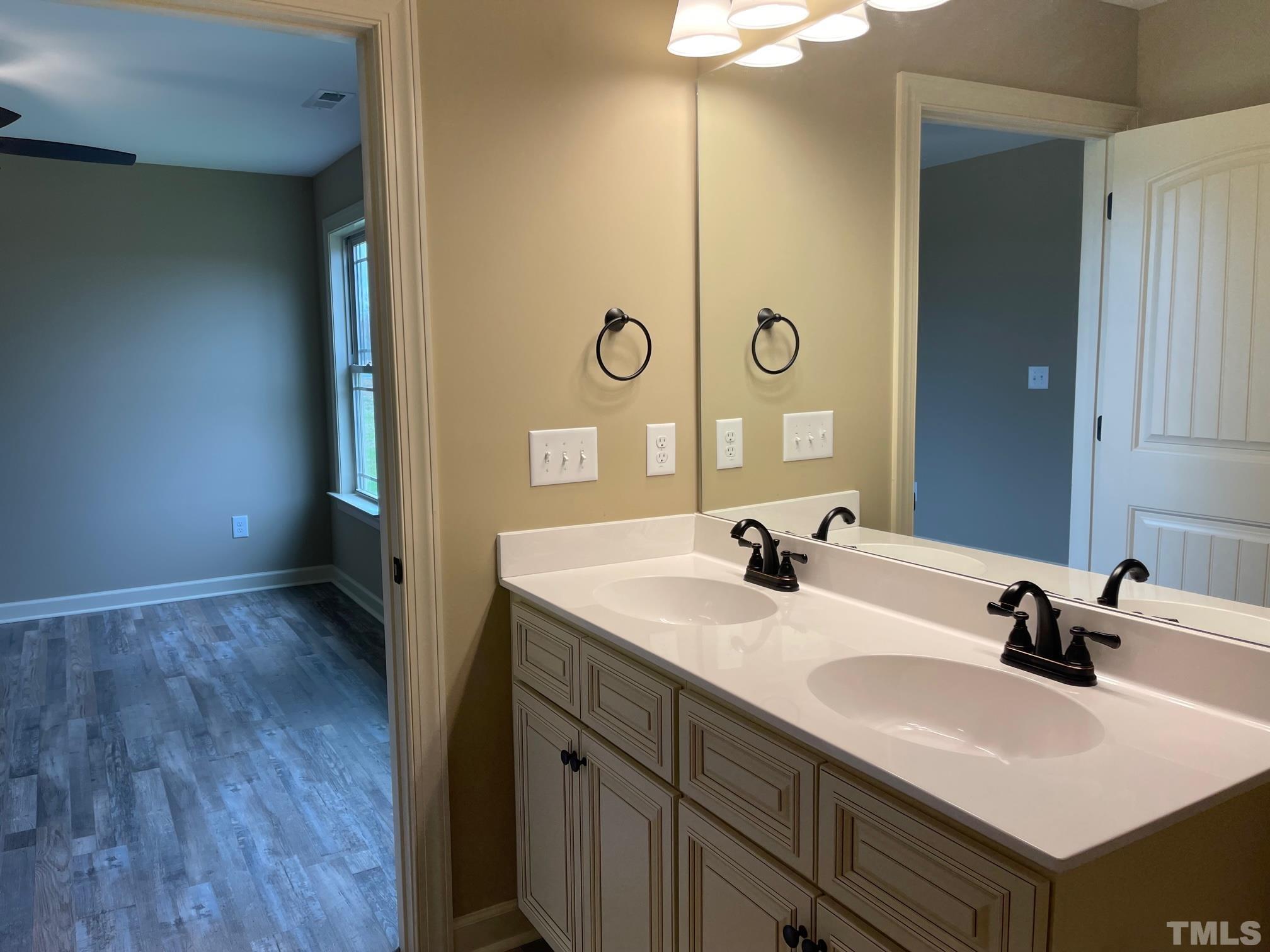 665 Bethel Church Road Angier, NC 27501 - Photo 21 of 32 a bathroom with a sink and a mirror
