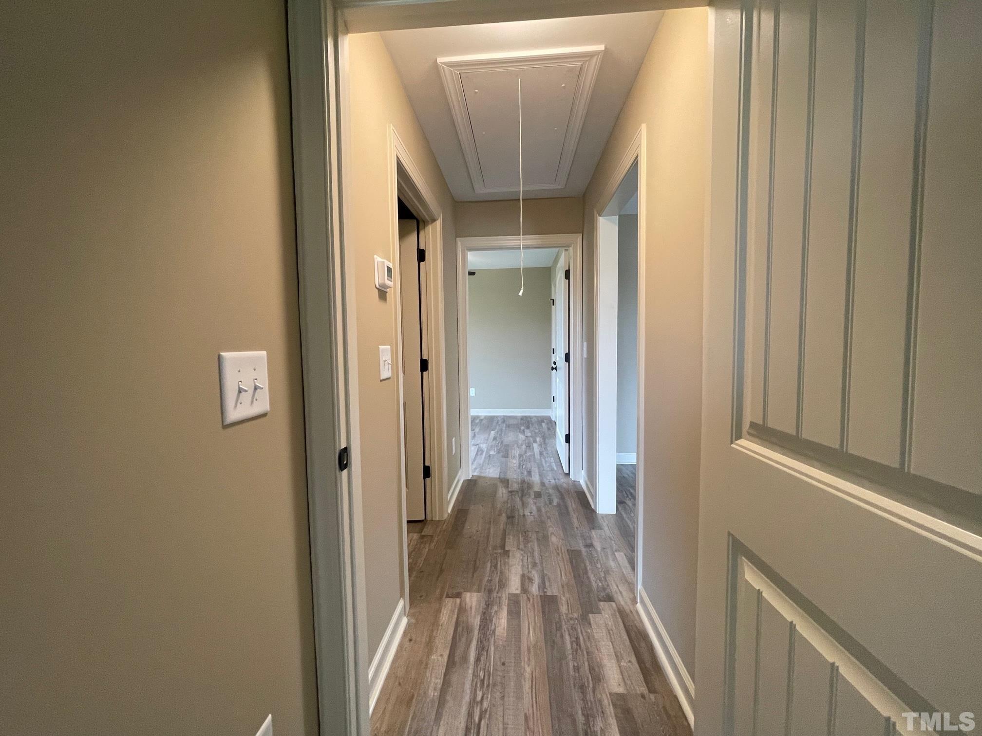 665 Bethel Church Road Angier, NC 27501 - Photo 23 of 32 a view of a hallway with wooden floor and a bathroom
