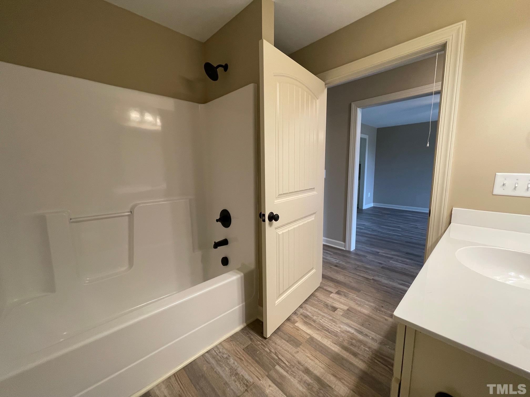 665 Bethel Church Road Angier, NC 27501 - Photo 26 of 32 a bathroom with a bathtub and a shower