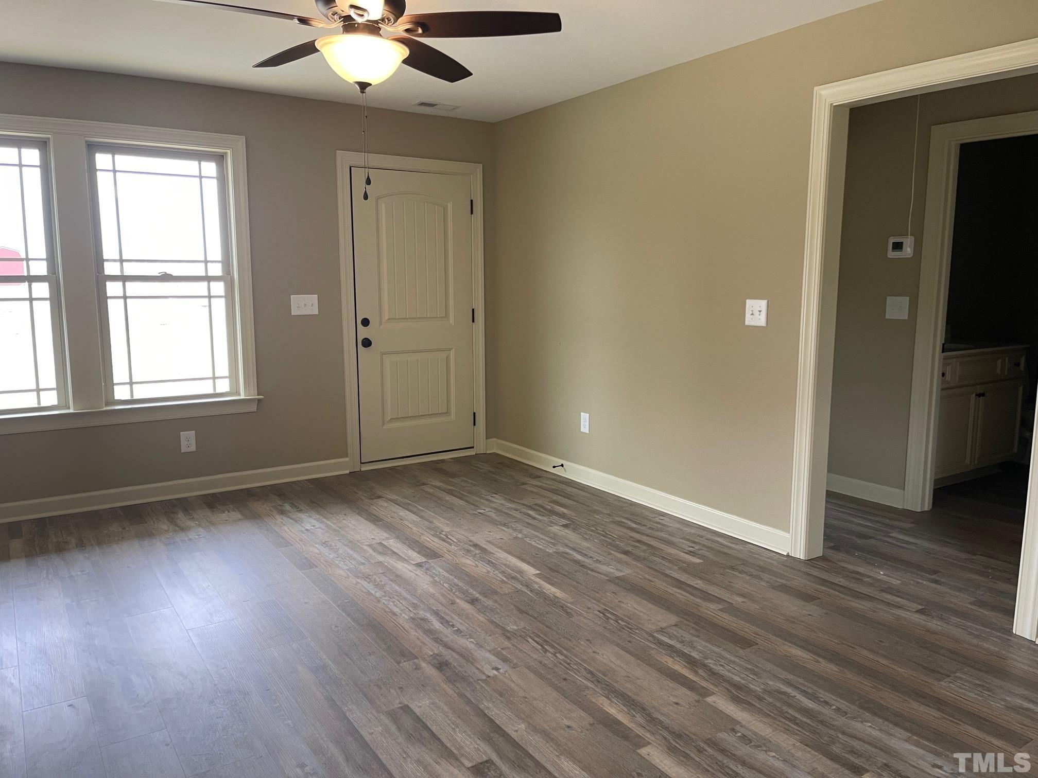 665 Bethel Church Road Angier, NC 27501 - Photo 4 of 32 an empty room with wooden floor and windows