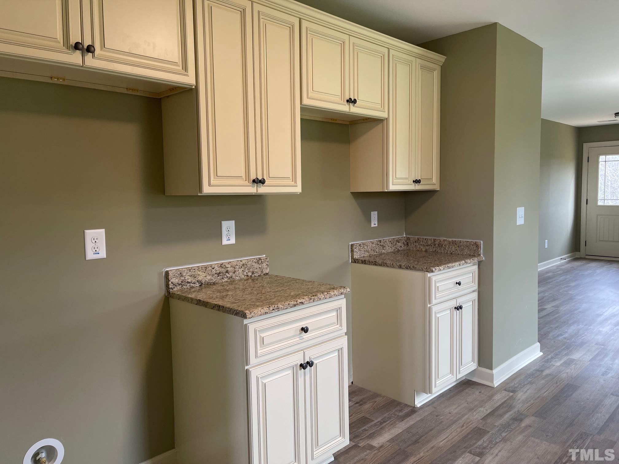 665 Bethel Church Road Angier, NC 27501 - Photo 8 of 32 a kitchen with stainless steel appliances granite countertop a stove a sink and white cabinets with wooden floor