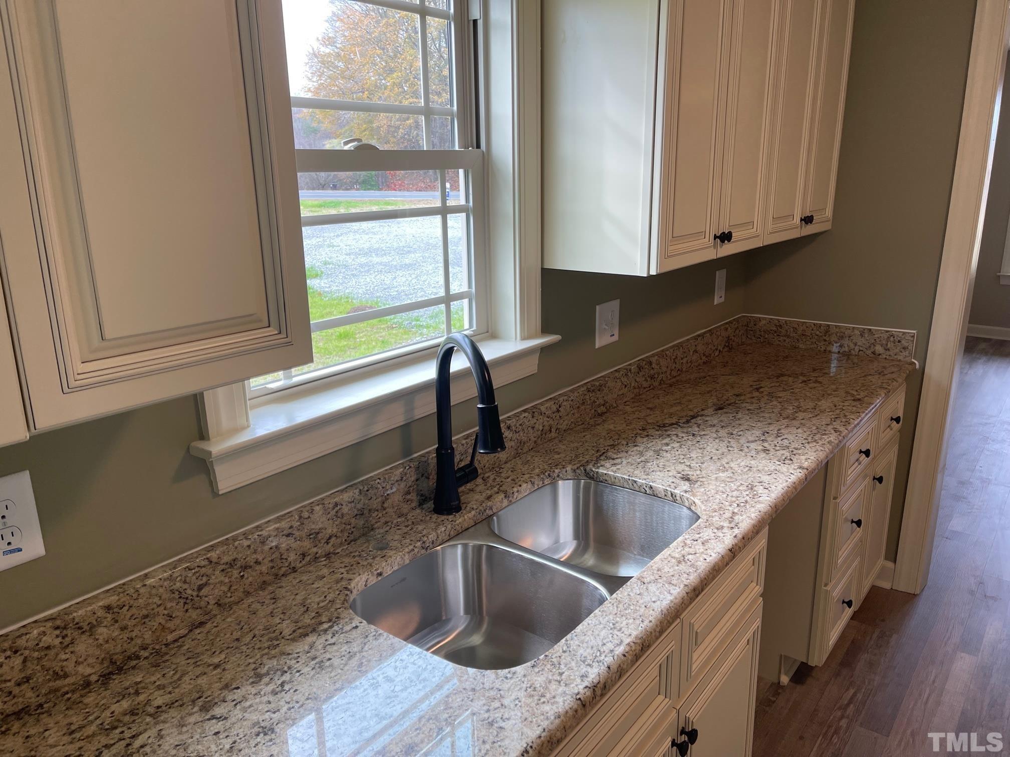 665 Bethel Church Road Angier, NC 27501 - Photo 9 of 32 a kitchen with granite countertop a sink and a window