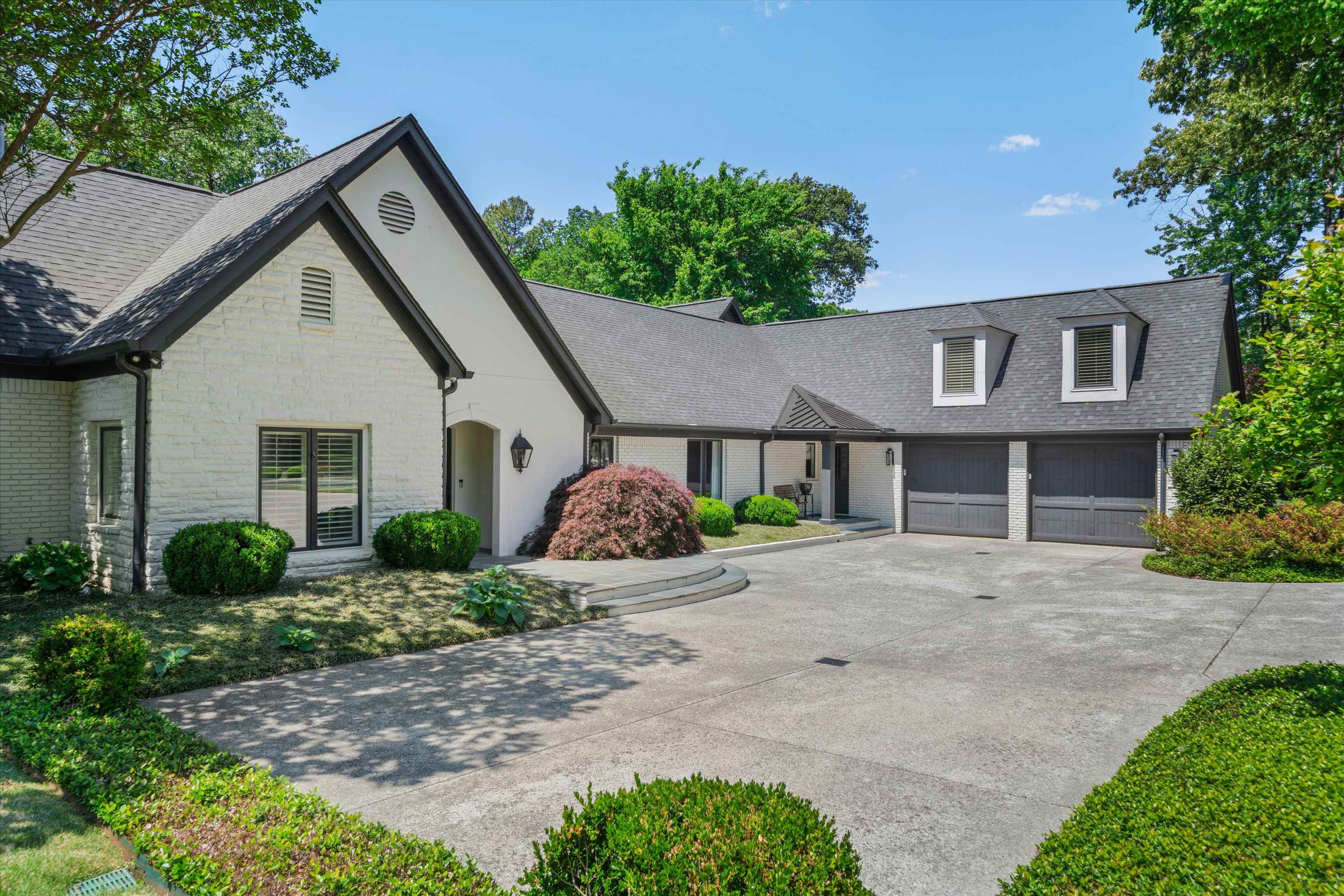 4710 Gwynne Road Memphis, TN 38117 - Photo 3 of 40 a front view of a house with a yard and garage