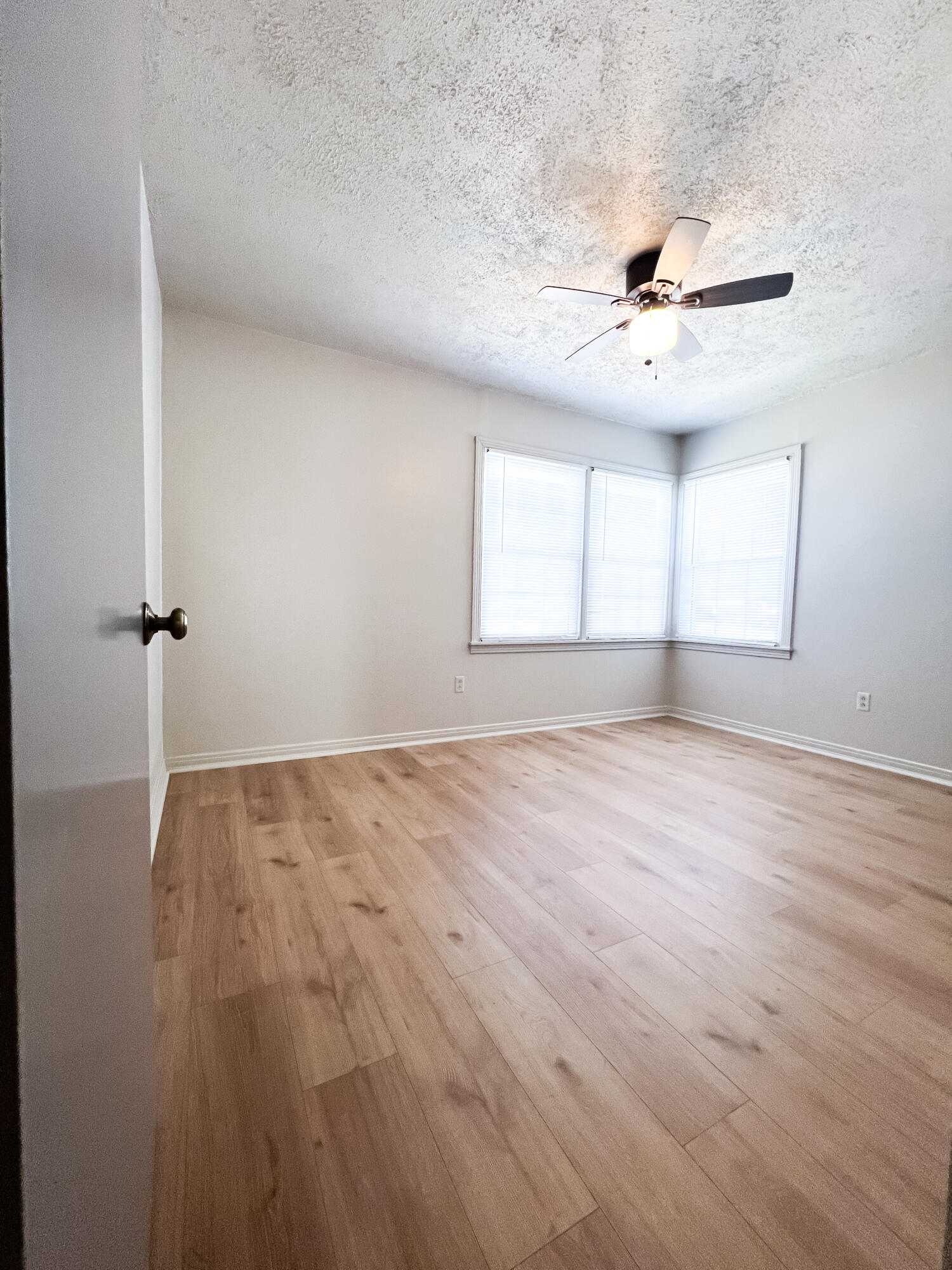1513 37th Street Lubbock, TX 79412 - Photo 11 of 34 wooden floor in an empty room with a window