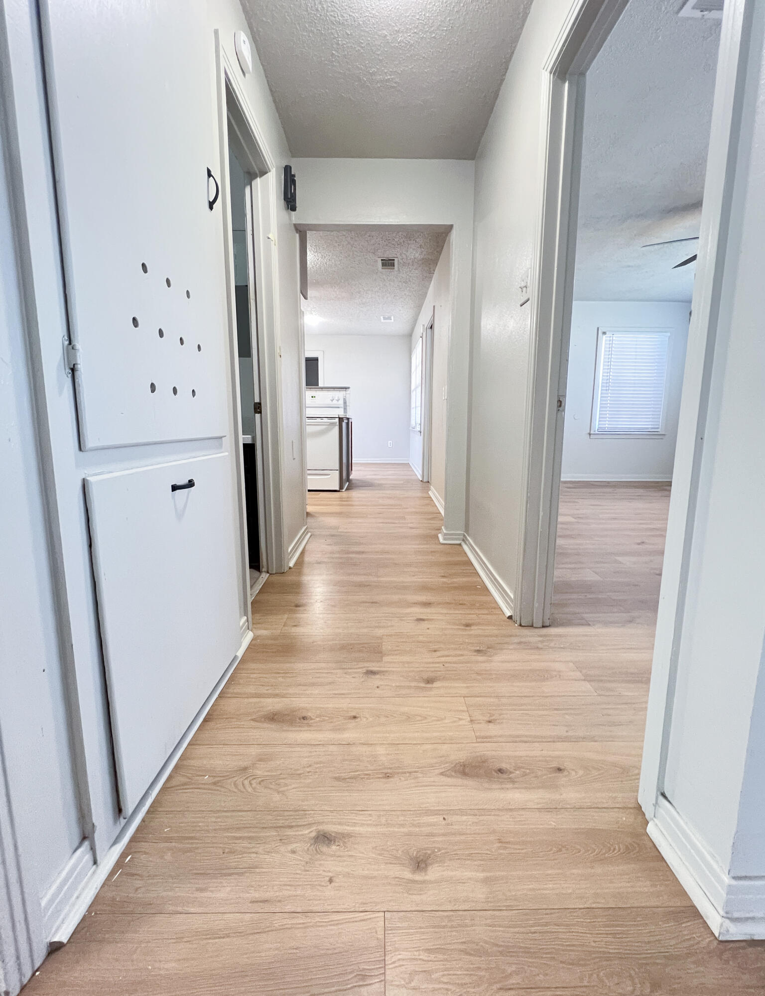 1513 37th Street Lubbock, TX 79412 - Photo 13 of 34 a view of a hallway with wooden floor