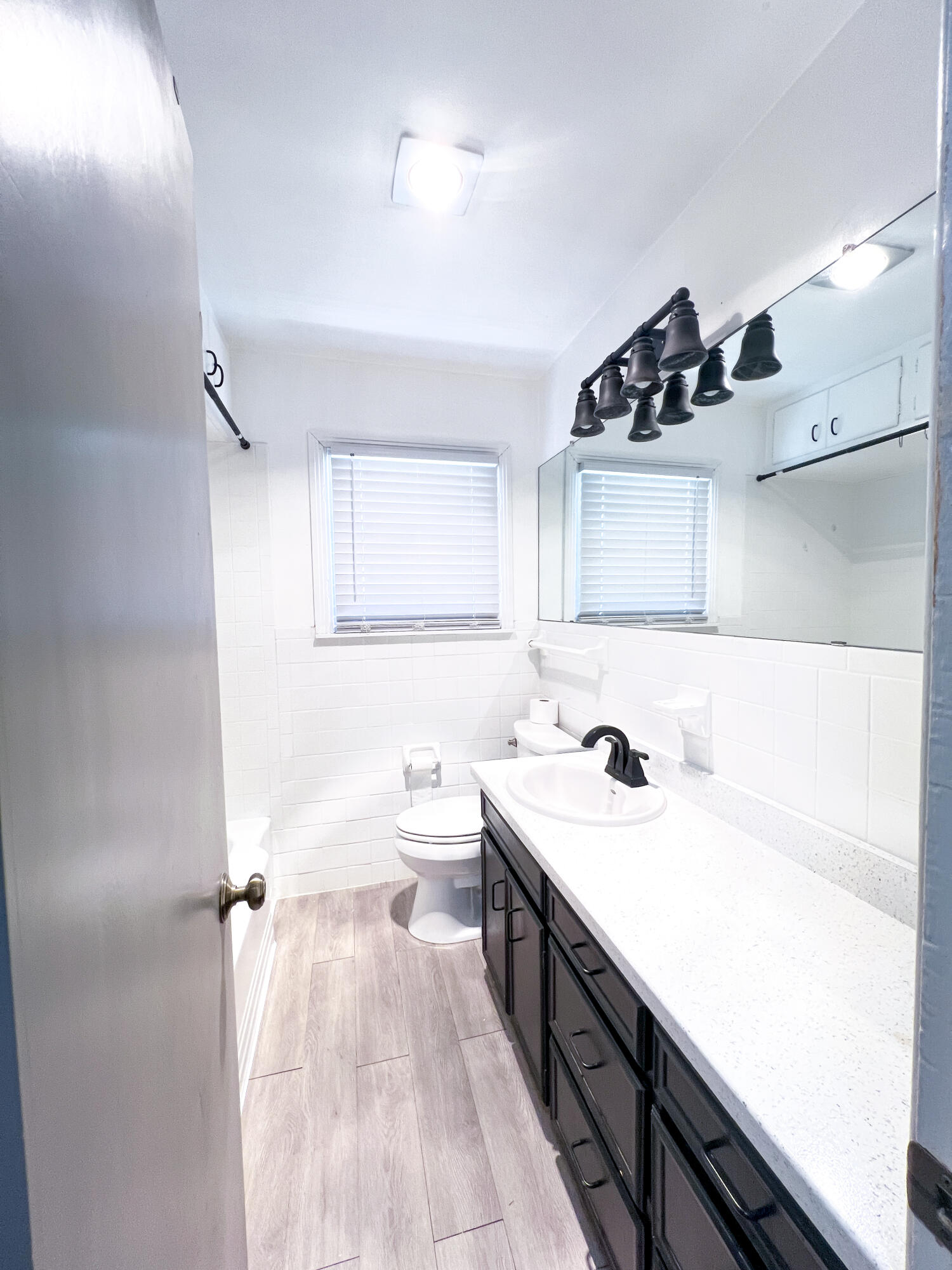 1513 37th Street Lubbock, TX 79412 - Photo 21 of 34 a bathroom with a sink a toilet and a mirror