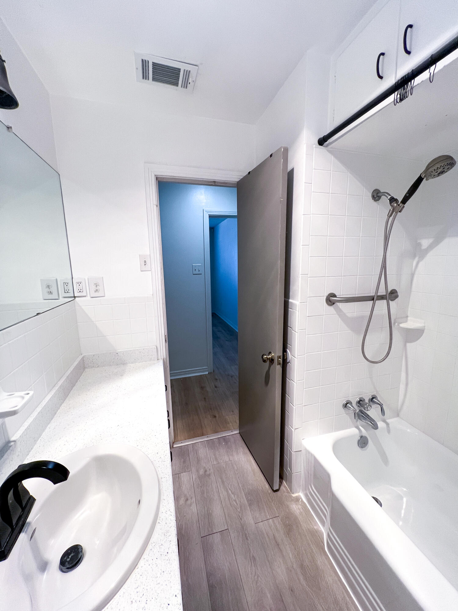 1513 37th Street Lubbock, TX 79412 - Photo 24 of 34 a bathroom with a tub sink and mirror