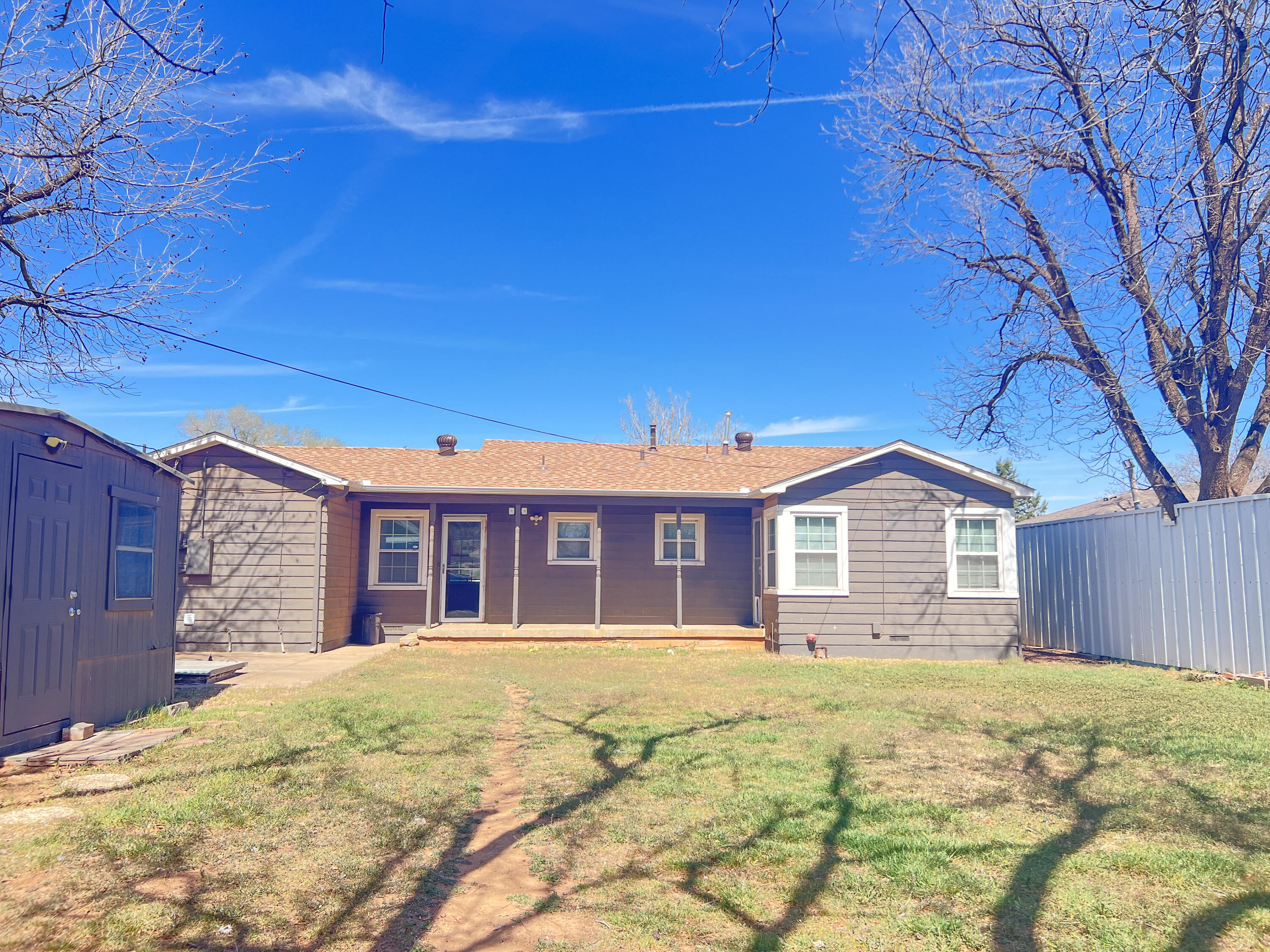 1513 37th Street Lubbock, TX 79412 - Photo 26 of 34 a front view of a house with a yard