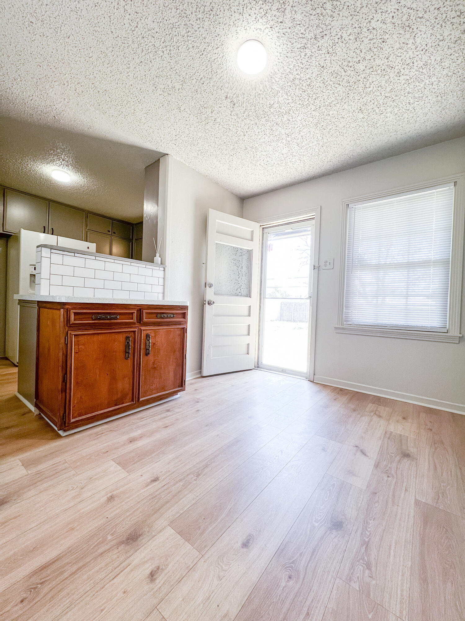 1513 37th Street Lubbock, TX 79412 - Photo 7 of 34 an empty room with wooden floor and windows