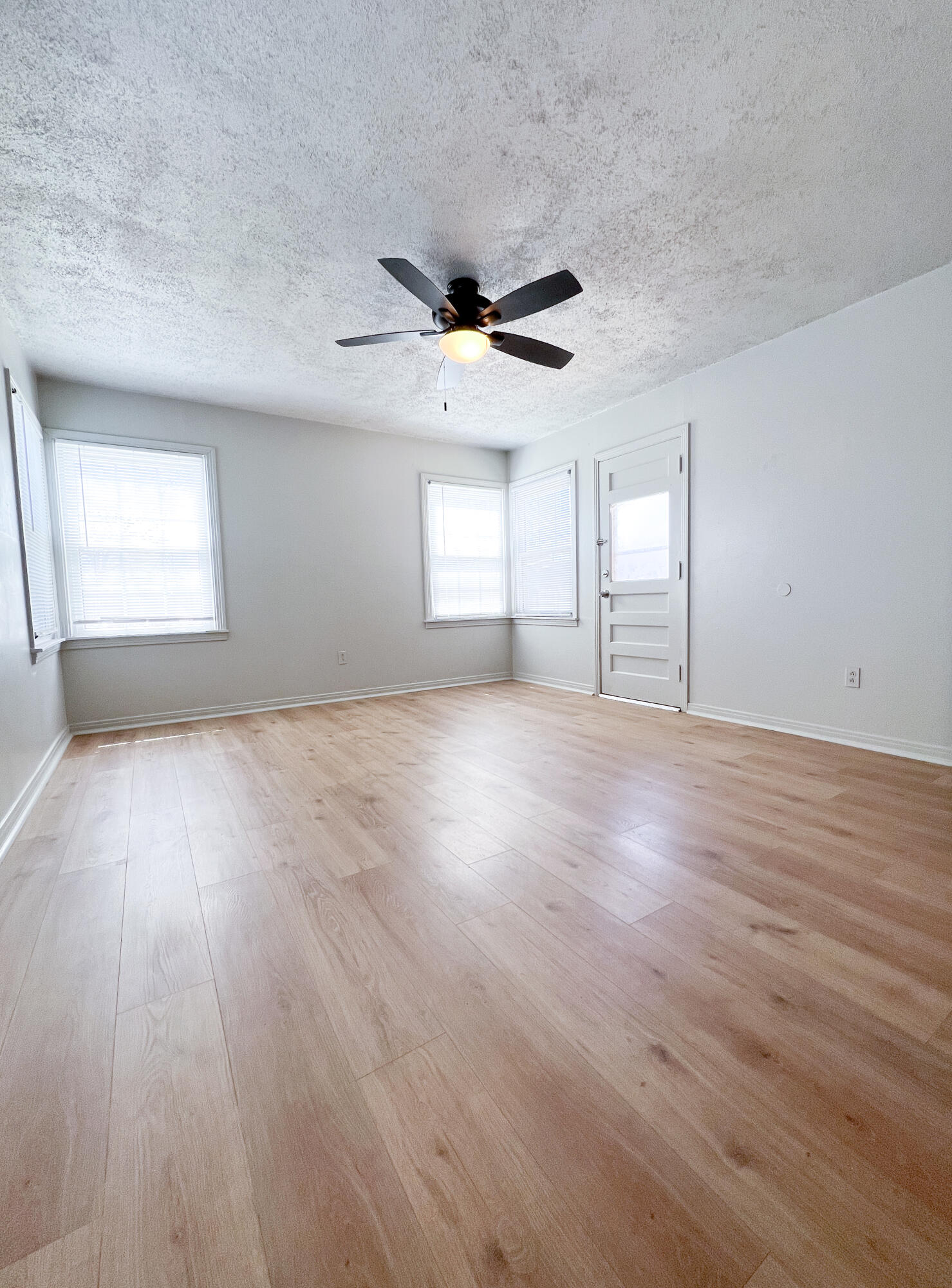 1513 37th Street Lubbock, TX 79412 - Photo 9 of 34 an empty room with wooden floor and windows