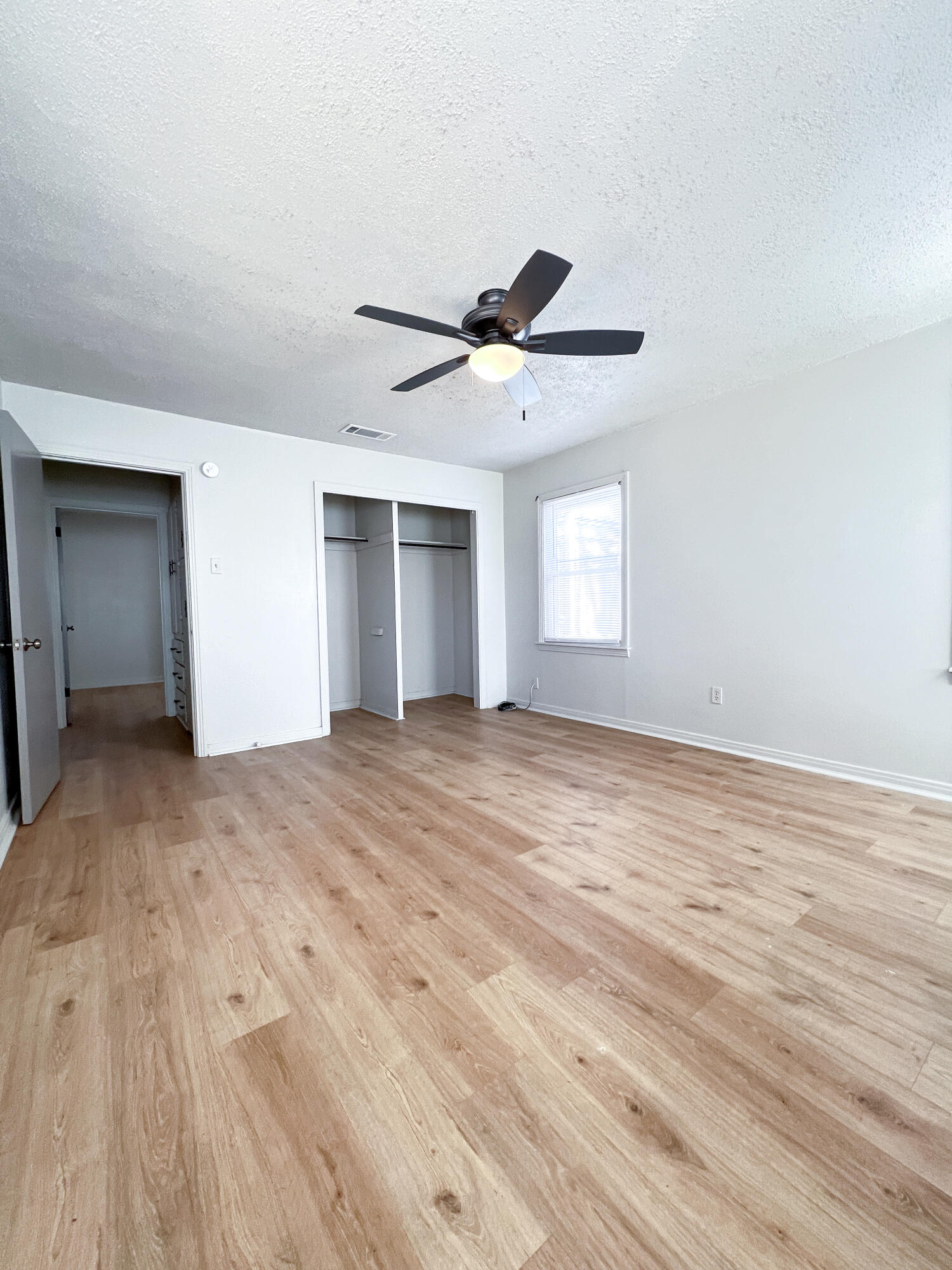 1513 37th Street Lubbock, TX 79412 - Photo 10 of 34 a view of empty room with wooden floor and fan