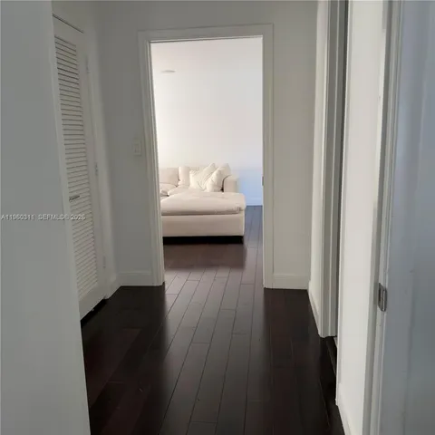 a view of bedroom with wooden floor and a sink
