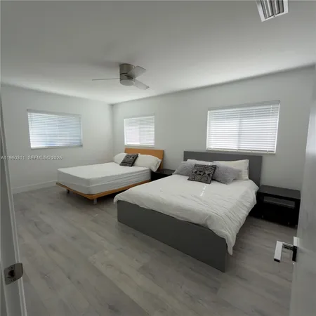 a bedroom with two beds and painted walls