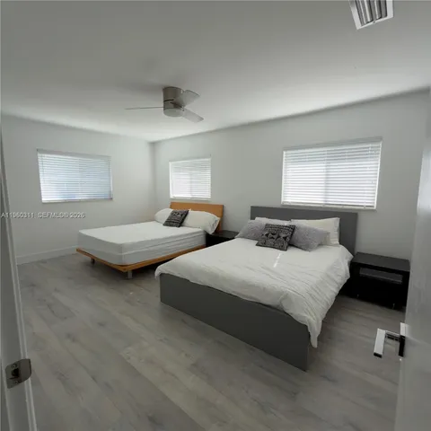 a bedroom with two beds and painted walls