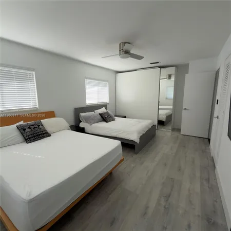 a bedroom with bed and window