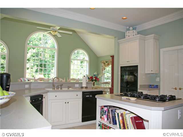3931 Reeds Landing Circle Midlothian, VA 23113 - Photo 6 of 12 a kitchen with a sink stove and cabinets