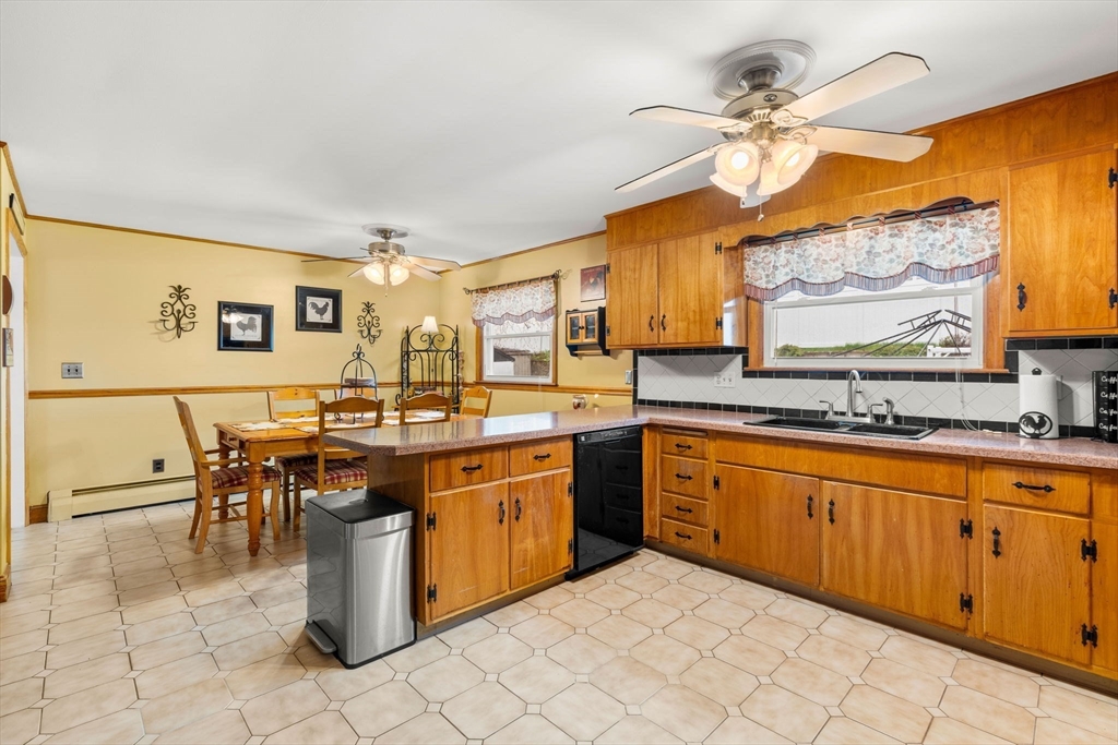8 Agnes Terrace Methuen, MA 01844 - Photo 11 of 41 a kitchen with stainless steel appliances granite countertop a sink a stove top oven a dining table and chairs with wooden floor