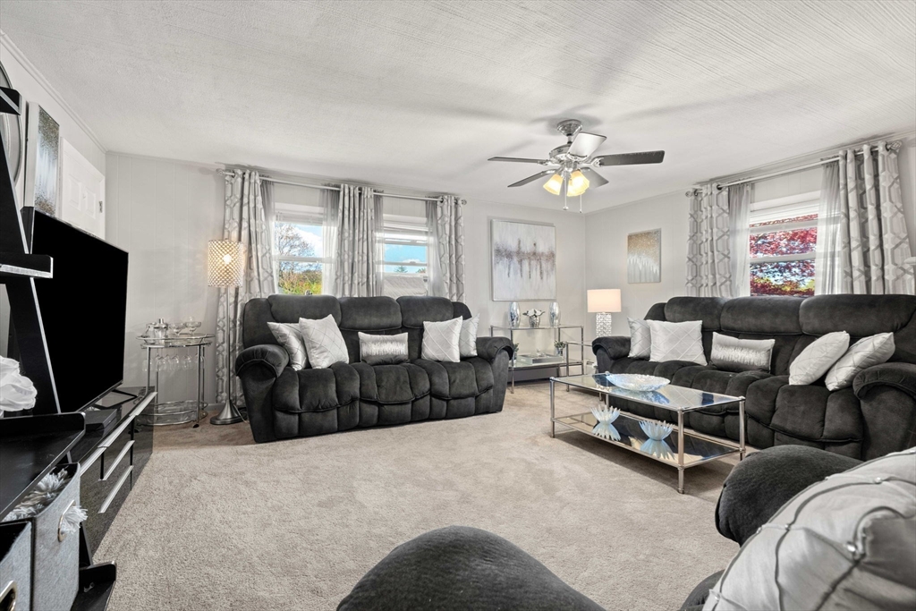 8 Agnes Terrace Methuen, MA 01844 - Photo 13 of 41 a living room with furniture a ceiling fan and a window