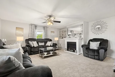 a living room with furniture and a fireplace