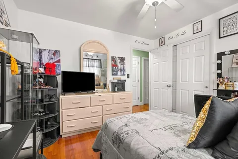 a bedroom with furniture and flat screen tv