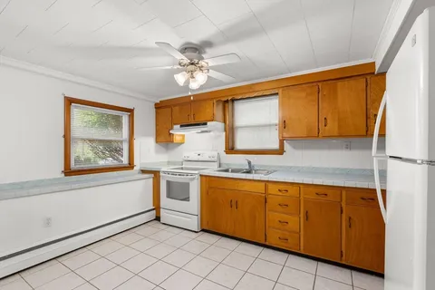 a kitchen with a sink cabinets and window