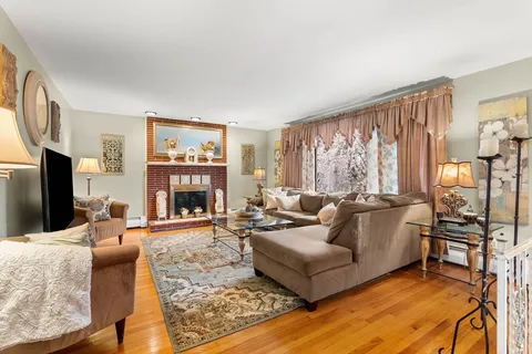 a living room with furniture fireplace and a flat screen tv