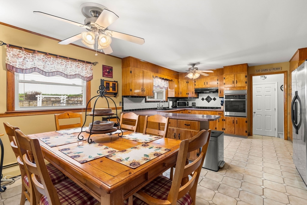 8 Agnes Terrace Methuen, MA 01844 - Photo 8 of 41 a view of a dining room with furniture a kitchen and chandelier
