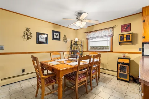 a view of a dining room with furniture and chandelier